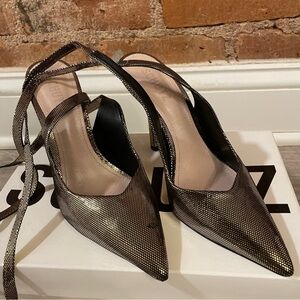 Schutz disco ball pumps in black and gold color.